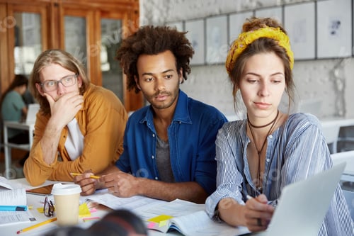 Preview: Portrait Of Three Collegues Or Partners Working Together At Coworking Space, Discussing Business