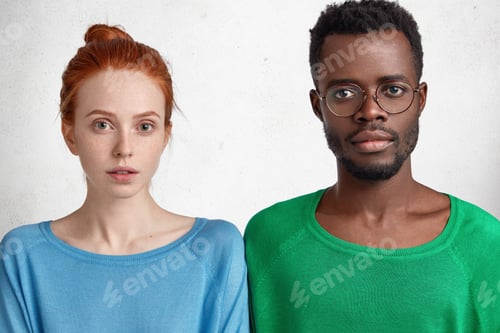 Preview: Two Lovely Friends Stnad Next To Each Other, Have Serious Expressions. Mixed Race Students Listen