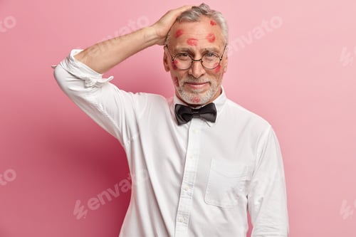 Preview: Senior Unshaven Man Director Keeps Hand On Head, Has Red Lipstick Traces On Face, Dressed In White