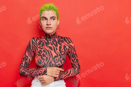 Preview: Horizontal Shot Of Thoughtful Hipster Girl Has Bright Dyed Green Short Hair Looks With Pensive