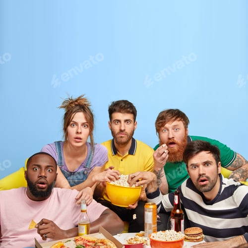 Preview: People, Leisure And Entertainment Concept. Impressed Friends Eat Salty Popcorn And Other Snack