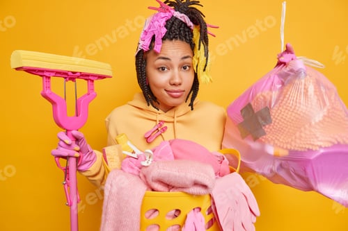 Preview: Service Woman With Dreadlocks Holds Trash Bag And Mop Poses Near Basin Of Laundry Busy With House