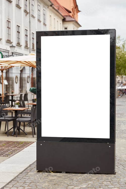 Preview: Vertical Shot Of Blank Billboard Stands On Pavemenet Against City Background Near Outdoor