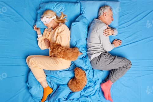 Preview: Full Length Shot Of Relaxed Senior Woman And Man Sleep On Bed Turn Back To Each Other Rest At Home