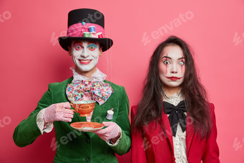 Preview: Photo Of Girl Ghost Has Scarying Makeup And Pleased Crazy Hatter In Costume Drinks Tea On Party
