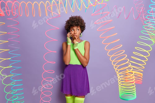 Preview: Beautiful Pensive Woman In Colorful Clothing, Wears Sport Gloves And Stockings, Talks Via Mobile