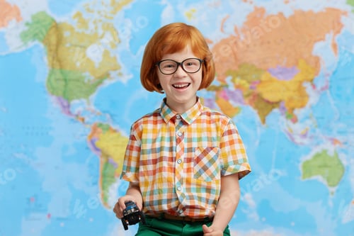 Preview: Portrait Of Playful Red Haired Little Boy In Colorful Clothes, Holding Toy Car In Hands, Having