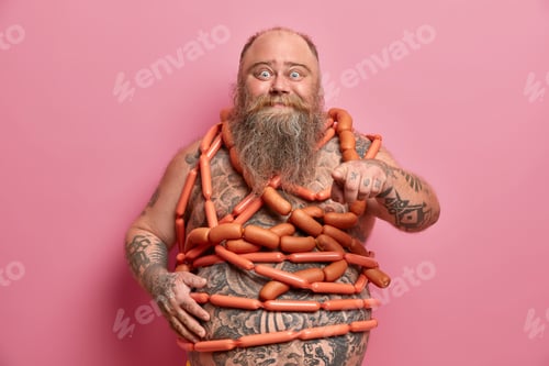 Preview: Happy Bearded Fat Man Points Directly At Camera, Wrapped With Sausages Over Naked Body, Breaks