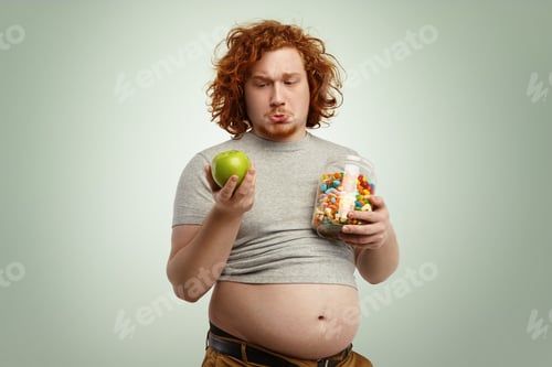 Preview: Studio Shot Of Thoughtful Indecisive Redhead Overweight Fat Man With Big Stomach Feeling Confused