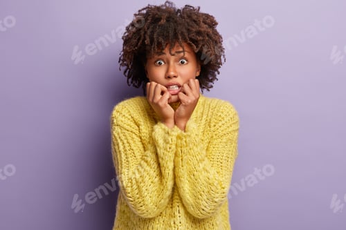 Preview: Image Of Nervous Dark Skinned Female Bites Finger Nails From Depression, Worries Because Of Hurt