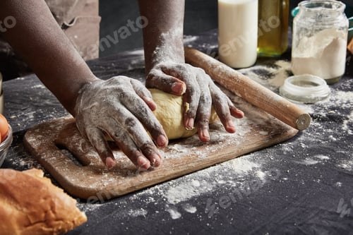 Preview: Indoor Shot Of Black Man With Dirty Hands Kneads Pasrty Or Dough Carefully, Uses Rolling Pin