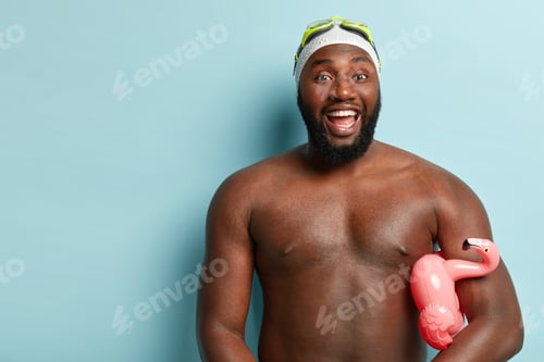 Preview: Summer Holidays Concept. Cheerful Athletic Man Has Dark Skin, Laughs And Shows White Teeth, Carries