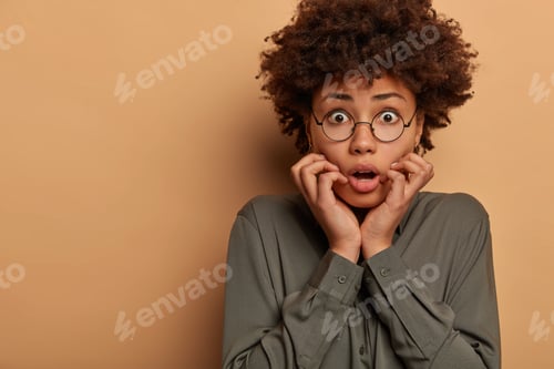 Preview: Frightened Emotional Woman Has Scared Alarmed Face Expression, Stares With Fear, Trembles Worried