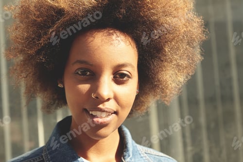 Preview: Flare Sun. Attractive Fashionable Black Student Girl With Facial Piercing Looking At Camera With
