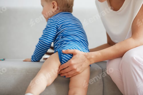 Preview: Young Mother With Her One Years Old Little Son Are Helps Son To Take The First Steps In The Bedroom
