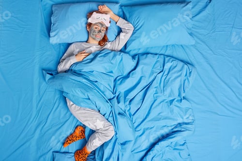 Preview: Relaxed Redhead European Woman Wakes Up Early In Morning Looks At Camera Applies Clay Beauty Mask