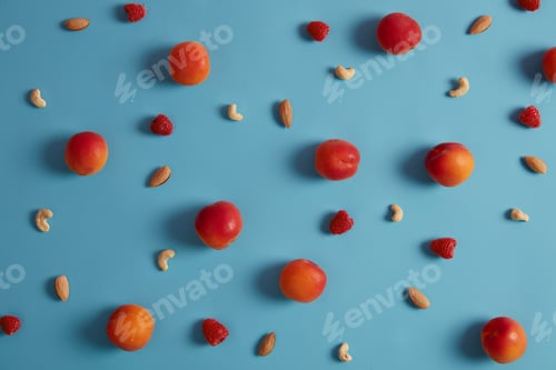 Preview: Set Of Ripe Peaches, Raspberry, Cashew And Almond Nuts On Blue Background. Ingredients For Tasty