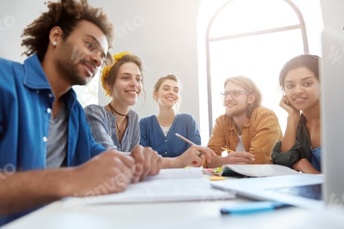 Preview: Smart Students From Different Countries Having Rest While Sitting At Their Work Place Looking At