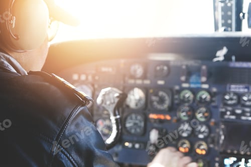 Preview: Caucasian Captain Piloting Airplane. Backview Of Professional Aviator In Sunglasses And Outfit