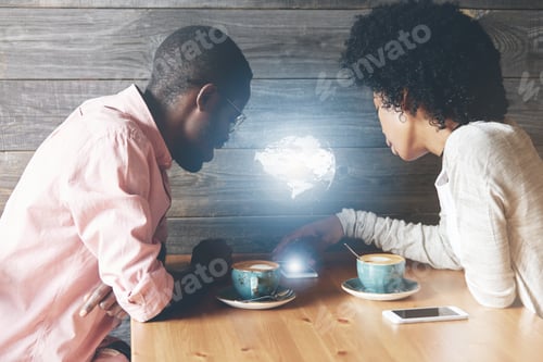 Preview: Global Or Worldwide Network Connection Concept. Young African Couple Sitting At The Wooden Table Of