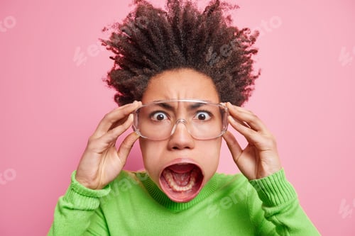 Preview: Close Up Shot Of Crazy Mad Shocked Afro American Woman Sees Something Terrifying Holds Hands On