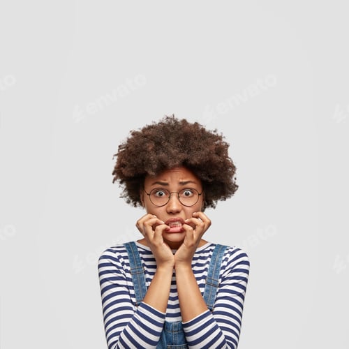 Preview: Frustrated Dark Skinned Mixed Race Female Bites Finger Nails Nervously, Being In Panic As Hears Bad