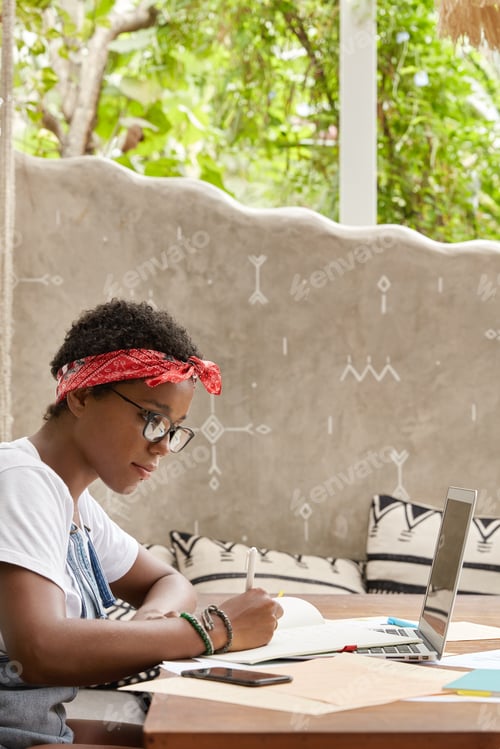 Preview: Photo Of Concentrated Freelancer Prepares Schedule For Working Day, Writes Down In Documents, Uses
