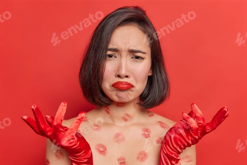 Preview: Frustrated Asian Woman Has Depressed Expression Looks Doleful Spreads Hands Feels Very Upset