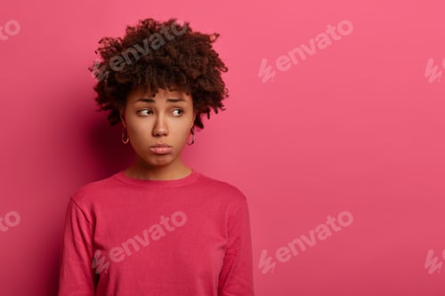 Preview: Disappointed Sad Woman With Afro Hair Looks Unhappily Aside, Being Bothered By Something, Regrets