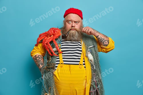 Preview: Strict Serious Bearded Sailor Curls Mustache Frowns Eyebrows And Looks Directly At Camera Poses