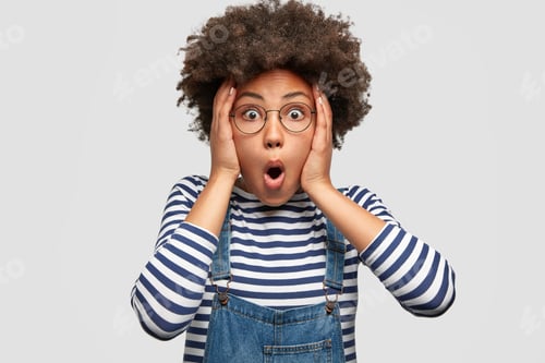 Preview: Stunned African American Female Stares At Camera And Keeps Mouth Opened, Scratches Head And Looks