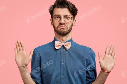 Preview: It`S Not My Business! Serious Honest Male Worker Keeps Palms Raised In Front, Shows That He Is Not