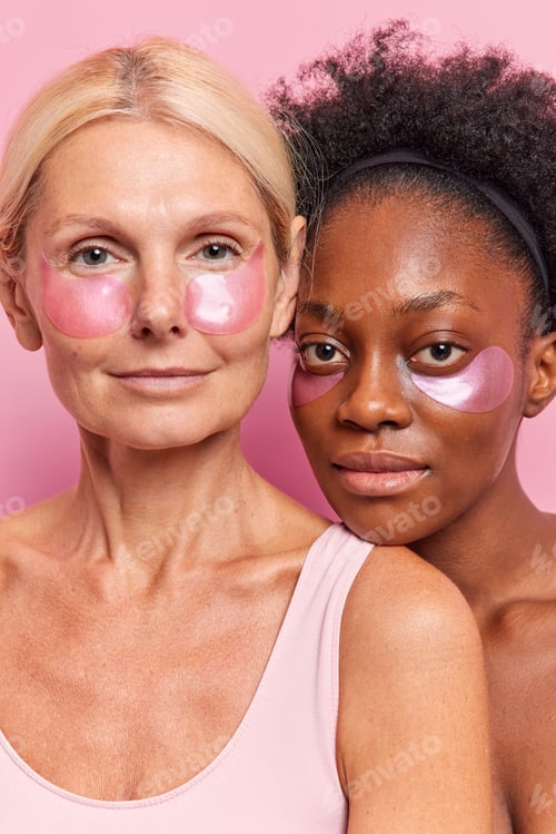 Preview: Old And Young Women Stand Closely To Each Oher Indoor Look Seriously At Camera Apply Hydrogel