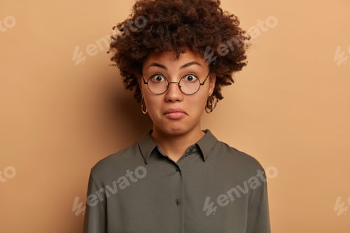 Preview: Headshot Of Curly Woman With Wondered Expression, Expresses Surprisement, Hears Intiguing News