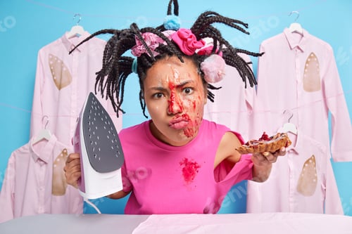 Preview: Discontent Stressed Woman Has Dirty Face Looks Indignant At Camera Holds Electric Iron Piece Of
