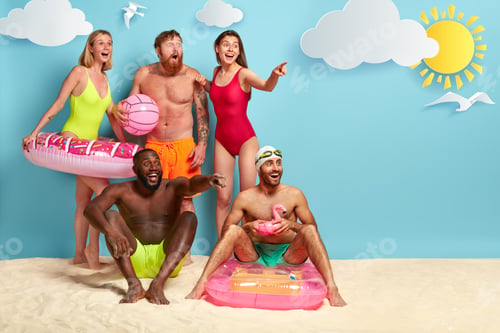 Preview: Happy Friends Spend Leisure Time At Beach, Hold Swimming Equipment, Gaze With Great Surprisement