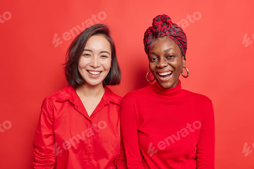 Preview: Horizontal Shot Of Happy Mixed Race Women Friends Smile Positively Enjoys Nice Day Spend Free Time