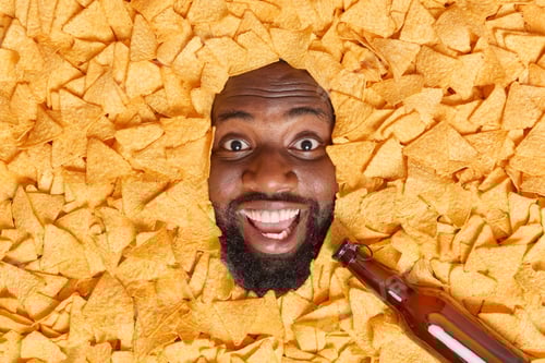 Preview: Perfect Snack For Beer. Cheerful Bearded Afro American Man With Dark Skin Drowned In Delicious