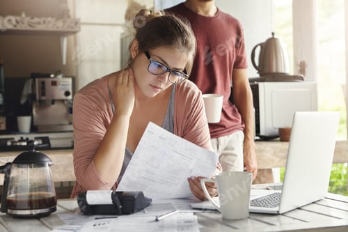 Preview: Unhappy Beautiful Woman Wearing Spectacles Having Concentrated Look Reading Notification Form Bank