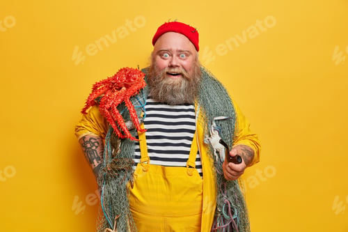 Preview: Positive Impressed Bearded Sailor In Striped Vest Poses With Red Octopus On Shoulder, Holds Smoking