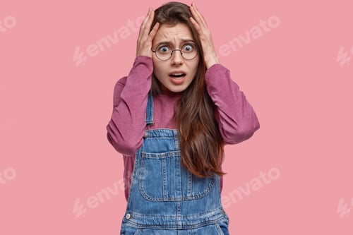Preview: Stressful Woman Keeps Hands On Head In Panic, Has Some Troubles, Stares With Scared Expression