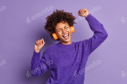 Preview: Happy Dark Skinned Woman Raises Arms Enjoys Cool Favorite Song Via Headphones Laughs Positively