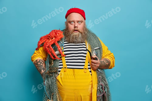 Preview: Stupefied Bearded Man Stares Bugged Eyes At Camera Holds Pipe Dressed In Yellow Overalls Red Hat