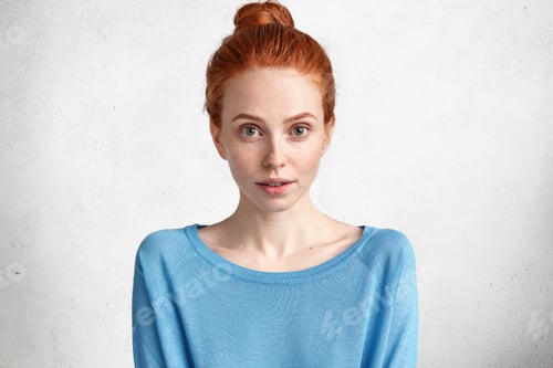 Preview: Portrait Of Attractive Foxy Female With Serious Expression, Looks Mysteriously At Camera, Wears