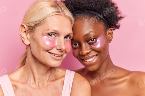 Preview: Photo Of Cheerful Two Diverse Women Use Skin Care Products Apply Beauty Patches Under Eyes Reduce