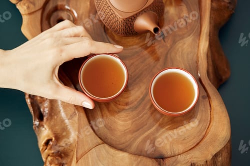 Preview: Top View Tea Set A Wooden Table For Tea Ceremony Background. Woman Holding A Cup Of Tea