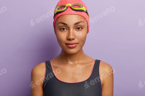 Preview: Close Up Portrait Of Serious Wet Dark Skinned Young Woman Has Calm Facial Expression, Enjoys