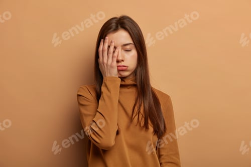 Preview: Distressed Fatigue Woman Covers Face With Palm, Feels Bored And Tired, Wants Sleep After All Night