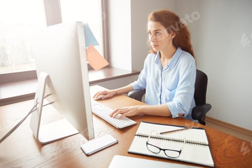 Preview: Serious Busy Female Office Worker, Keyboarding On The Computer, Sitting In The Office