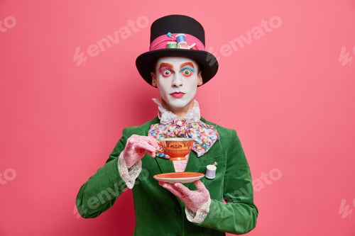 Preview: Surprised Hatter Drinks Tea With Aristocraic Manners Wears Tall Hat And Green Costume Has Image Of
